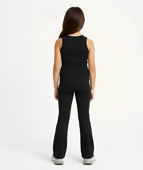 Girl styled in a black sleeveless tank top and matching ribbed pants for everyday activewear, shown from the back, available in sizes 3–14