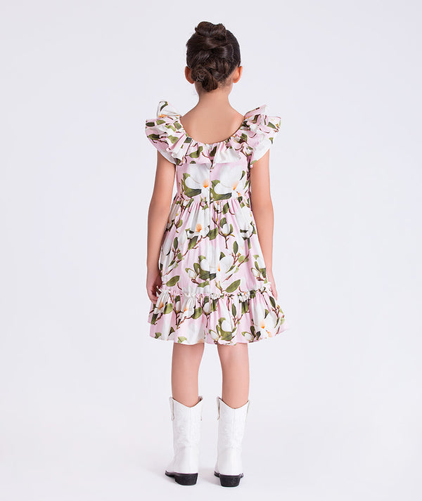 Back view of Mama Luma girls floral dress showing the softly gathered waist and ruffle hem for family gatherings and celebrations, sizes 3–12