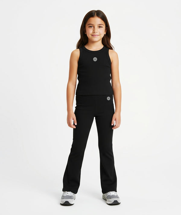 Girl modeling a black sleeveless top paired with coordinating flared pants, designed for minimalist daily wear, school-ready styling, and easy athleisure looks, available in sizes 3–14