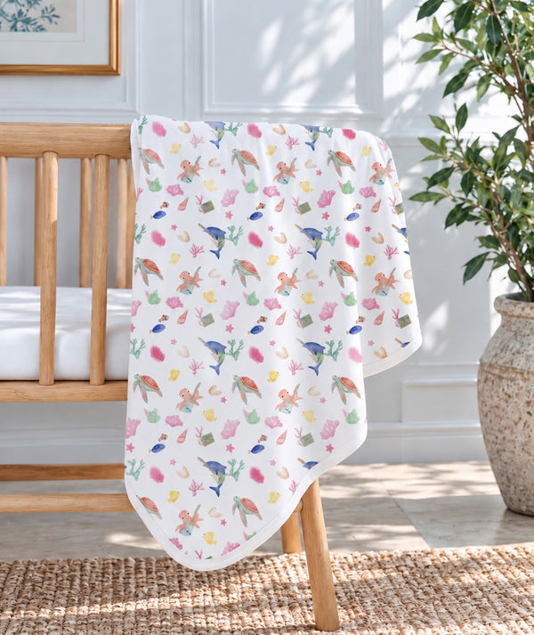 Ocean-print baby blanket, cozy nursery essential.