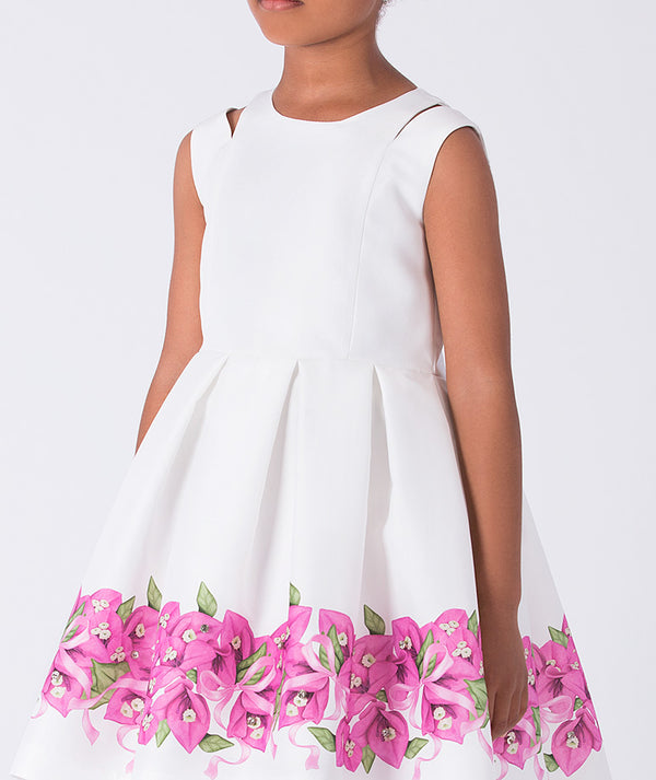 White dress with pink floral patterns on a white background