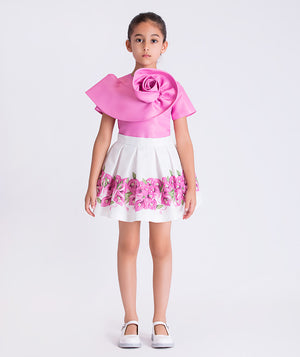 Bougainvillea crystals girls outfit worn by a 6-year-old girl, featuring a sculptural pink top and floral skirt for special occasions.