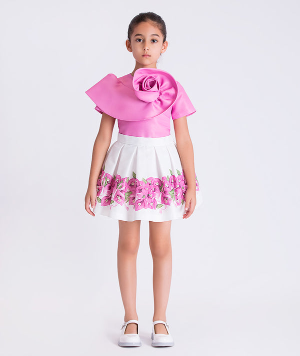 Bougainvillea crystals girls outfit worn by a 6-year-old girl, featuring a sculptural pink top and floral skirt for special occasions.