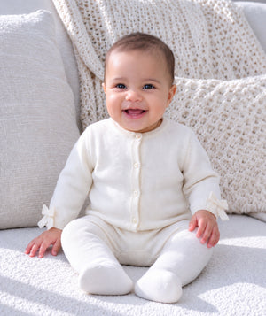 Baby portrait showcasing soft knit baby clothing and accessories.