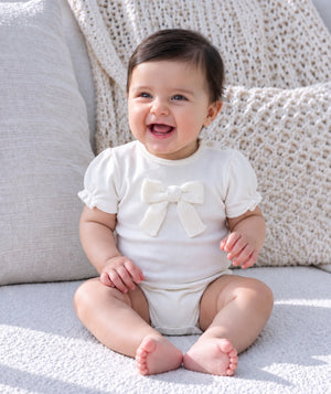 Baby in soft knitwear, photographed for a baby clothing editorial.