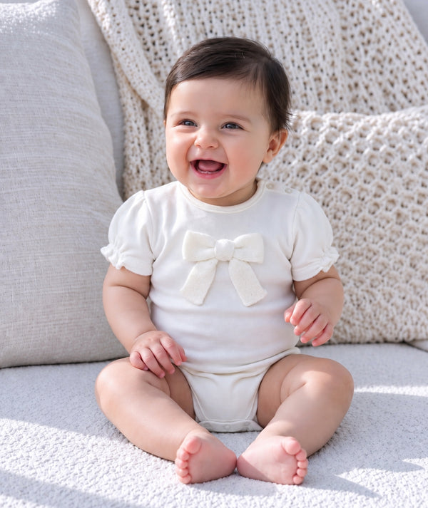 Baby in soft knitwear, photographed for a baby clothing editorial.
