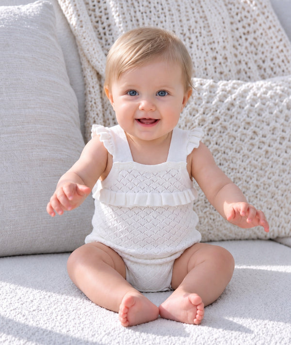 Baby wearing cozy knitted clothing in an editorial portrait.