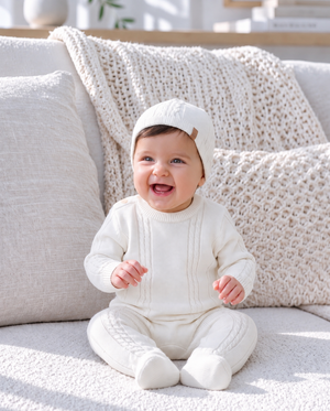 Baby wearing comfortable knit clothing in a joyful baby fashion portrait.