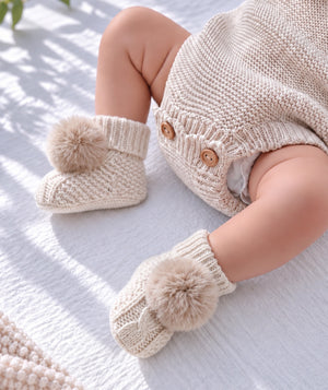 Cream puff baby booties, soft newborn footwear and baby gift accessory.