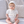 Charger l'image dans la galerie, Baby wearing an ivory knitted bonnet in a cozy portrait showcasing soft baby accessories.
