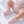 Charger l'image dans la galerie, Pink knitted baby booties in a product detail photograph.

