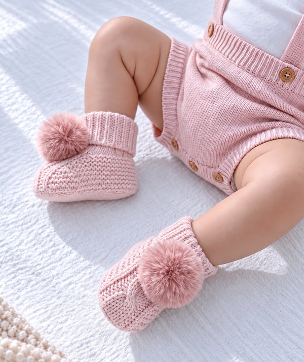Pink puff baby booties, soft footwear for newborn outfits and baby gifts.