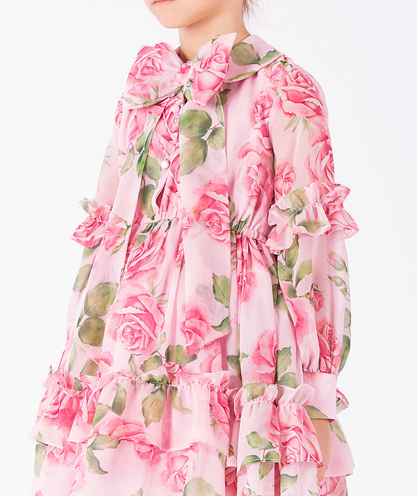 Editorial view of Chiffon Layers Rose Girls Dress in pink chiffon for girls ages 3 to 12, featuring fabric texture and color