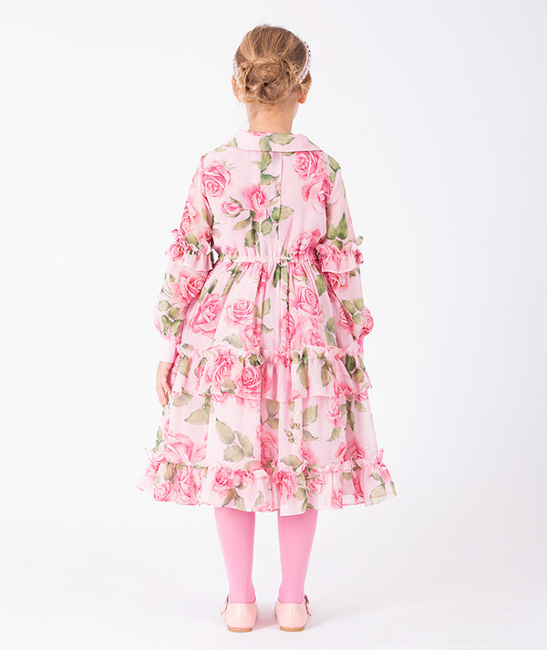 Editorial view of Chiffon Layers Rose Girls Dress in pink chiffon for girls ages 3 to 12, featuring neckline, sleeves and embellishments