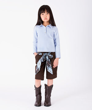 Front view of Classic Plaid Girls Bow Outfit with collared blue top, tailored chocolate shorts and plaid bow for girls ages 3 to 12 by Mama Luma.