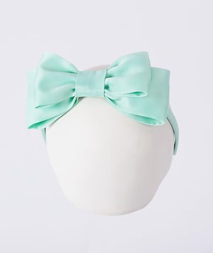 Mint green headband with a large bow on a white background for kids