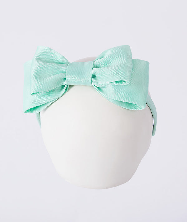 Mint green headband with a large bow on a white background for kids