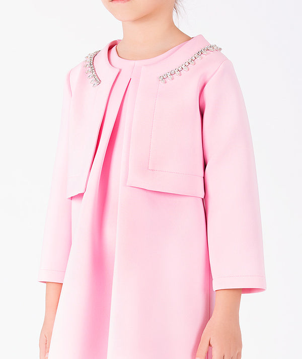 Close-up of blush pink girls jacket with crystal neckline