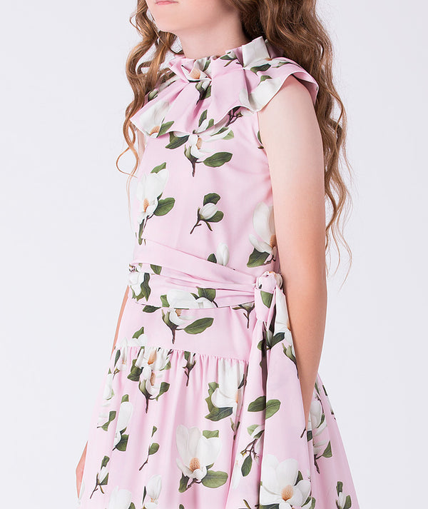 Close-up of Mama Luma girls floral dress highlighting the ruffle neck detail, smooth fabric texture, and floral pattern, designed for elegant events, sizes 3–12