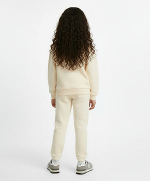 Girl wearing cream cotton sportswear top, premium kids active style ages 3 to 14