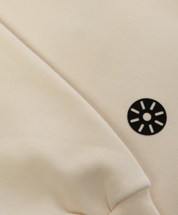 Close-up of cream cotton athletic fabric with premium texture for kidswear