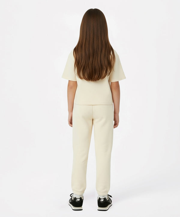Back view of cream girls active t-shirt and jogger set — soft short-sleeve top paired with relaxed joggers, perfect for school days, playground outings, sports practice, and everyday comfort; available in sizes 3–14 years.