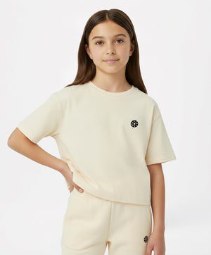 Cream short-sleeve girls active t-shirt with logo, perfect for school days, sports practice, playdates, and everyday comfort, available in sizes 3–14Y.