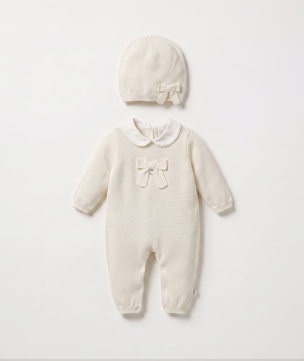 Ivory bow knit baby romper with matching beanie luxury baby outfit with Peter Pan collar perfect for special occasions