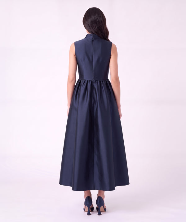 Back view of the Crystal Collar Navy Women’s Dress from Mama Luma’s Suva Maia Collection, featuring a full satin skirt and concealed back zipper.