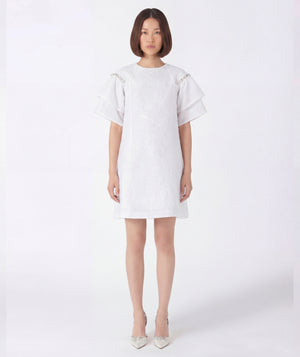 Woman wearing a white dress on a white background