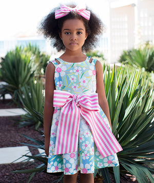 blue floral summer dress with a big, pink and white striped bow on the waist