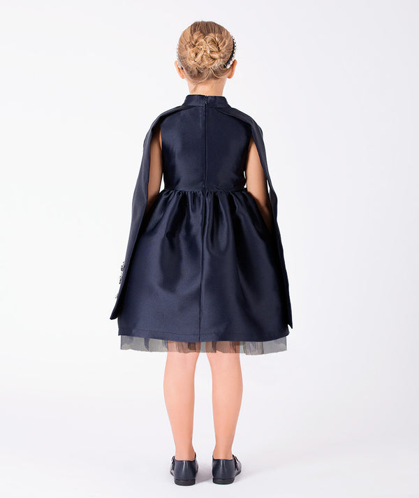 Back view of Diamond-Embellished Girls Cape Dress in navy tulle for girls ages 3 to 12, showing the silhouette and refined construction