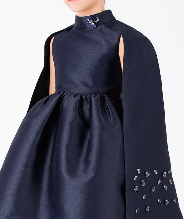 Close-up of Diamond-Embellished Girls Cape Dress in navy tulle for girls ages 3 to 12, highlighting fabric texture and designer details