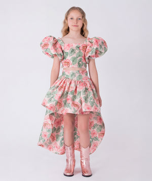 Front view of the Puff Sleeve High-Low Skirt Outfit featuring a puff-sleeve top with zip closure and a flowing high-low floral skirt made from breathable lightweight fabric, designed for girls ages 3–12 for Eid celebrations and garden events.