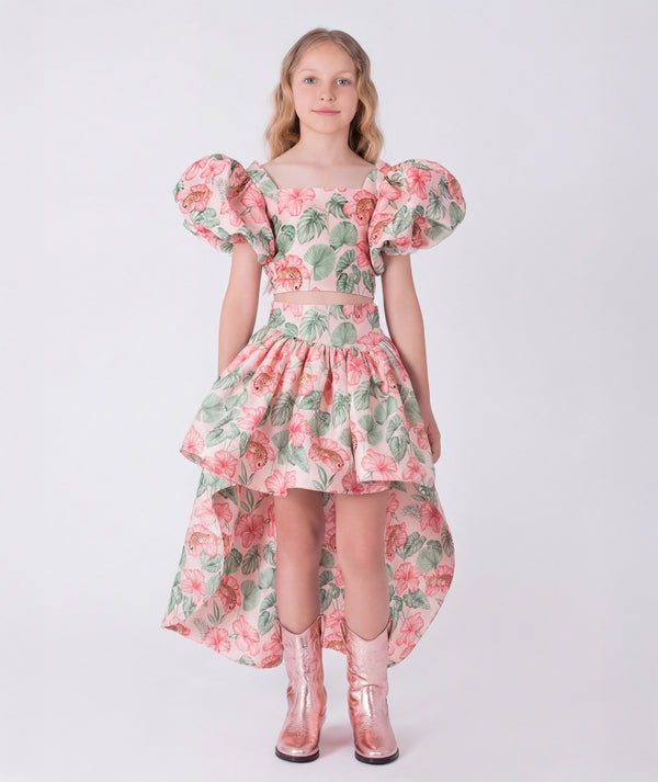 Front view of the Puff Sleeve High-Low Skirt Outfit featuring a puff-sleeve top with zip closure and a flowing high-low floral skirt made from breathable lightweight fabric, designed for girls ages 3–12 for Eid celebrations and garden events.
