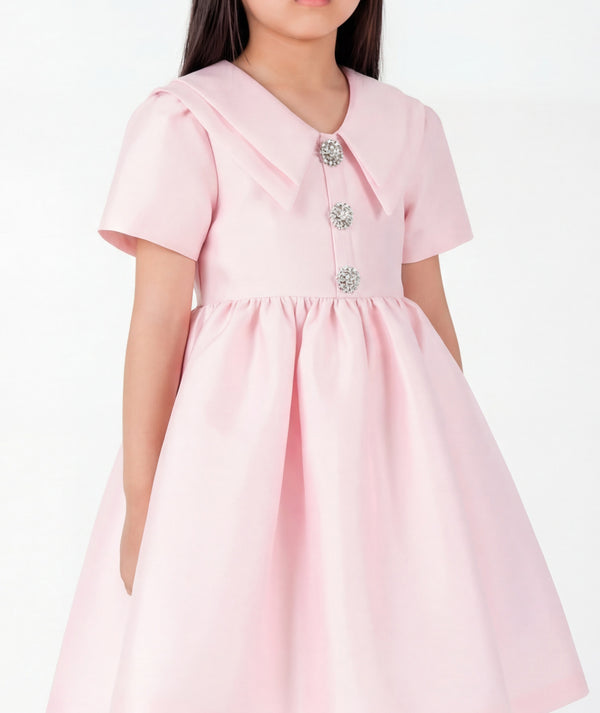 Close-up of Enchanting Brooch Girls Dress in blush pink structured matte satin for girls ages 3 to 12, highlighting tailoring, closure and finishing