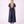 Load image into Gallery viewer, Back view of the Enchanting Brooch Women’s Dress from Mama Luma’s Suva Maia Collection, featuring a layered collar and full navy satin skirt.
