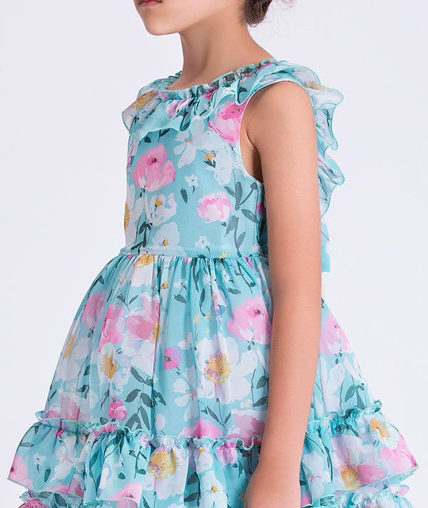 Close-up of Enchanting Chiffon Girls Dress showing lightweight chiffon fabric, floral print, and ruffled shoulder detail.