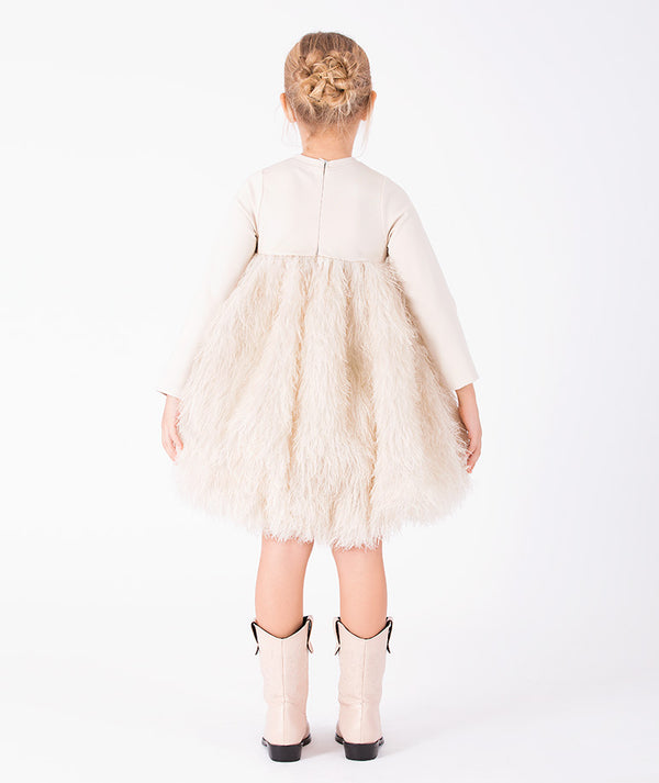Back view of Enchanting Feathers Girls Dress in beige with a voluminous feather-textured skirt for girls ages 3 to 12 by Mama Luma.