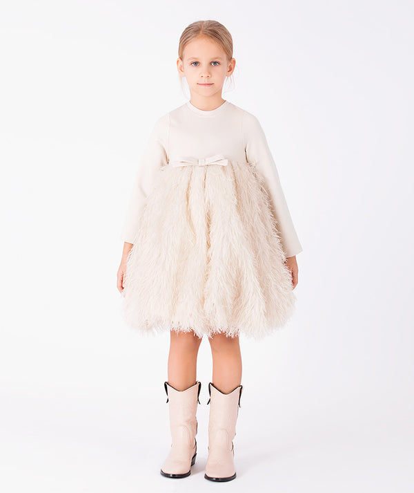 Front view of Enchanting Feathers Girls Dress in beige with long sleeves, tonal bow and feather-textured skirt for girls ages 3 to 12 by Mama Luma.