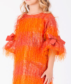 Close-up of Enchanting Feathers Girls Dress in coral feather for girls ages 3 to 12, highlighting fabric texture and designer details