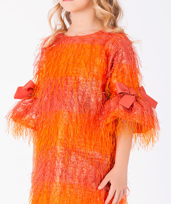 Close-up of Enchanting Feathers Girls Dress in coral feather for girls ages 3 to 12, highlighting fabric texture and designer details