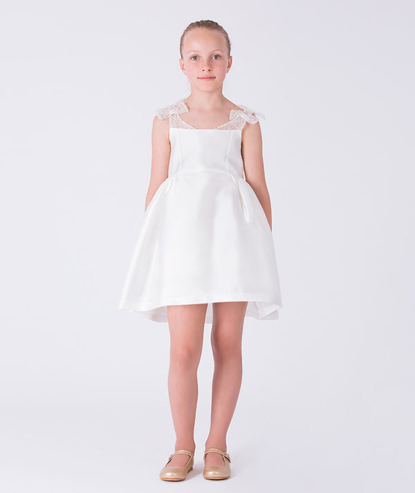 Front view of ivory Exquisite Bow Girls Dress with embellished sheer straps and flared A-line skirt.