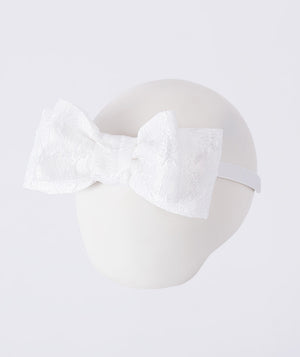 Exquisite jacquard bow headband with oversized woven bow, designed to complement girls’ special occasion outfits with elegant detail.
