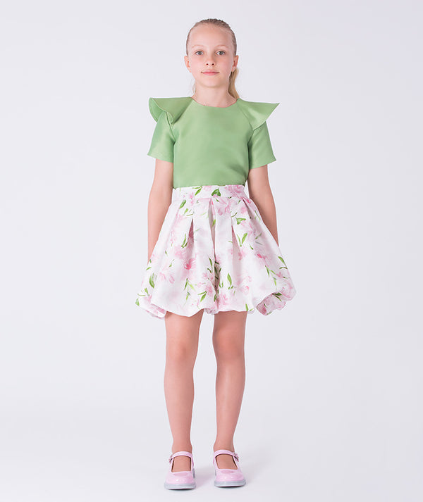 Front view of a flared floral girls outfit with structured green top and floral skirt, designed for elegant daytime occasions.
