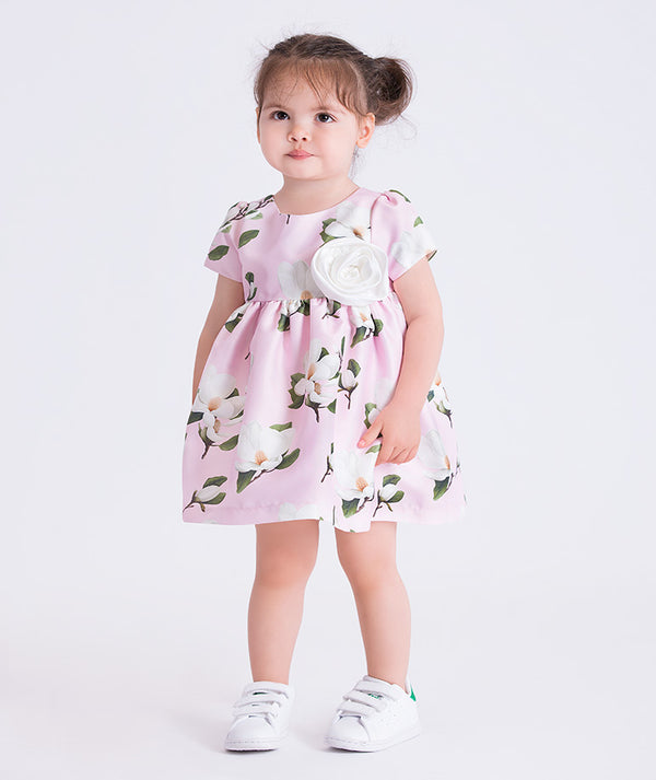 Pink floral baby dress featuring a 3D flower appliqué, by Mama Luma