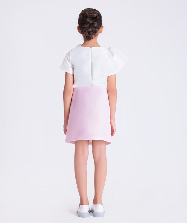 back view of girls two-piece outfit with floral appliqué top and elegant skirt by Mama Luma