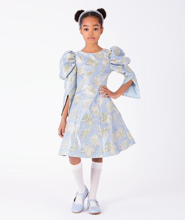 Floral Jacquard Girls Dress in powder blue with statement puff sleeves and flared skirt front view