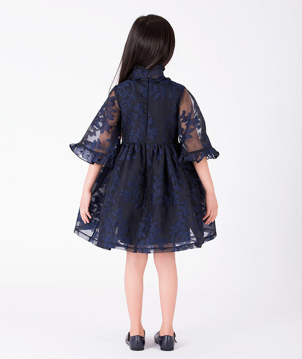 Back view of Floral Lace Cape Girls Dress in navy floral lace for girls ages 3 to 12, showing the silhouette and refined construction