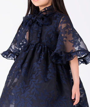Editorial view of Floral Lace Cape Girls Dress in navy floral lace for girls ages 3 to 12, styled for weddings, birthdays and special occasions